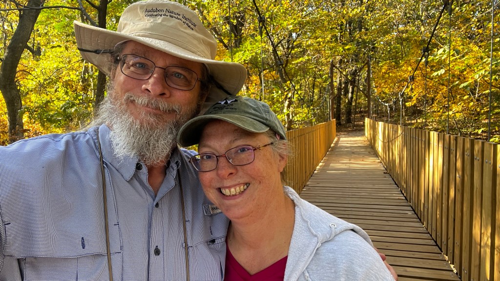 Paul and Julie on a wooden bridge.