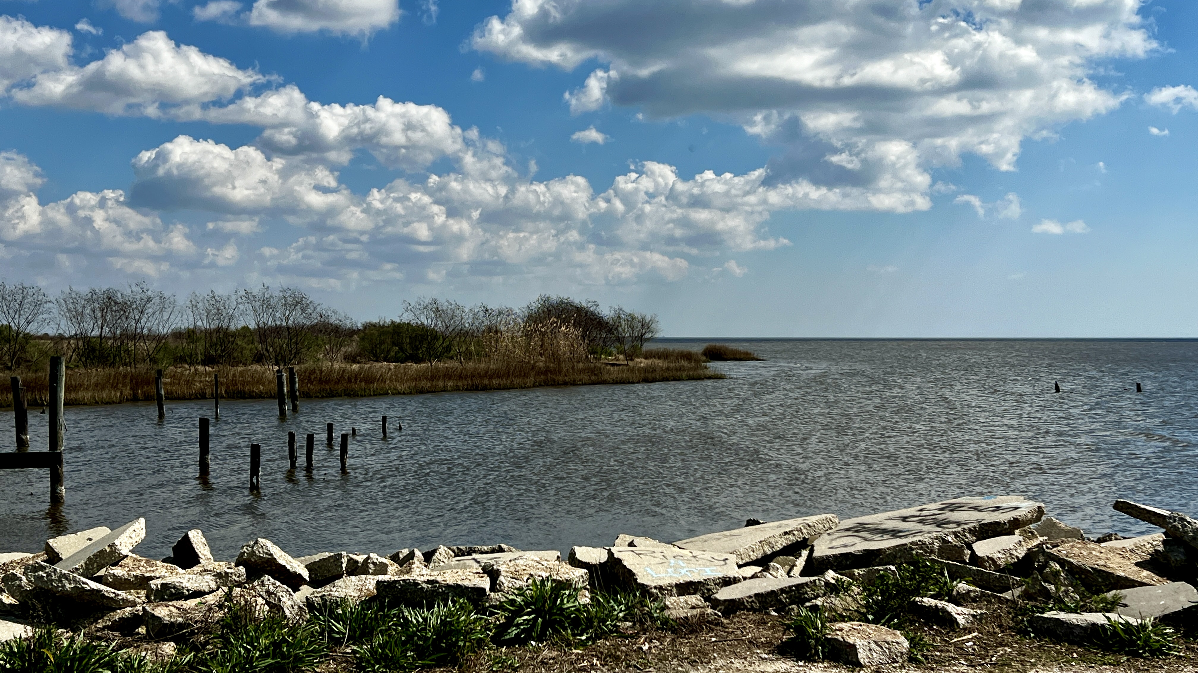 Lake scene with rocks and abandoned pier pilings