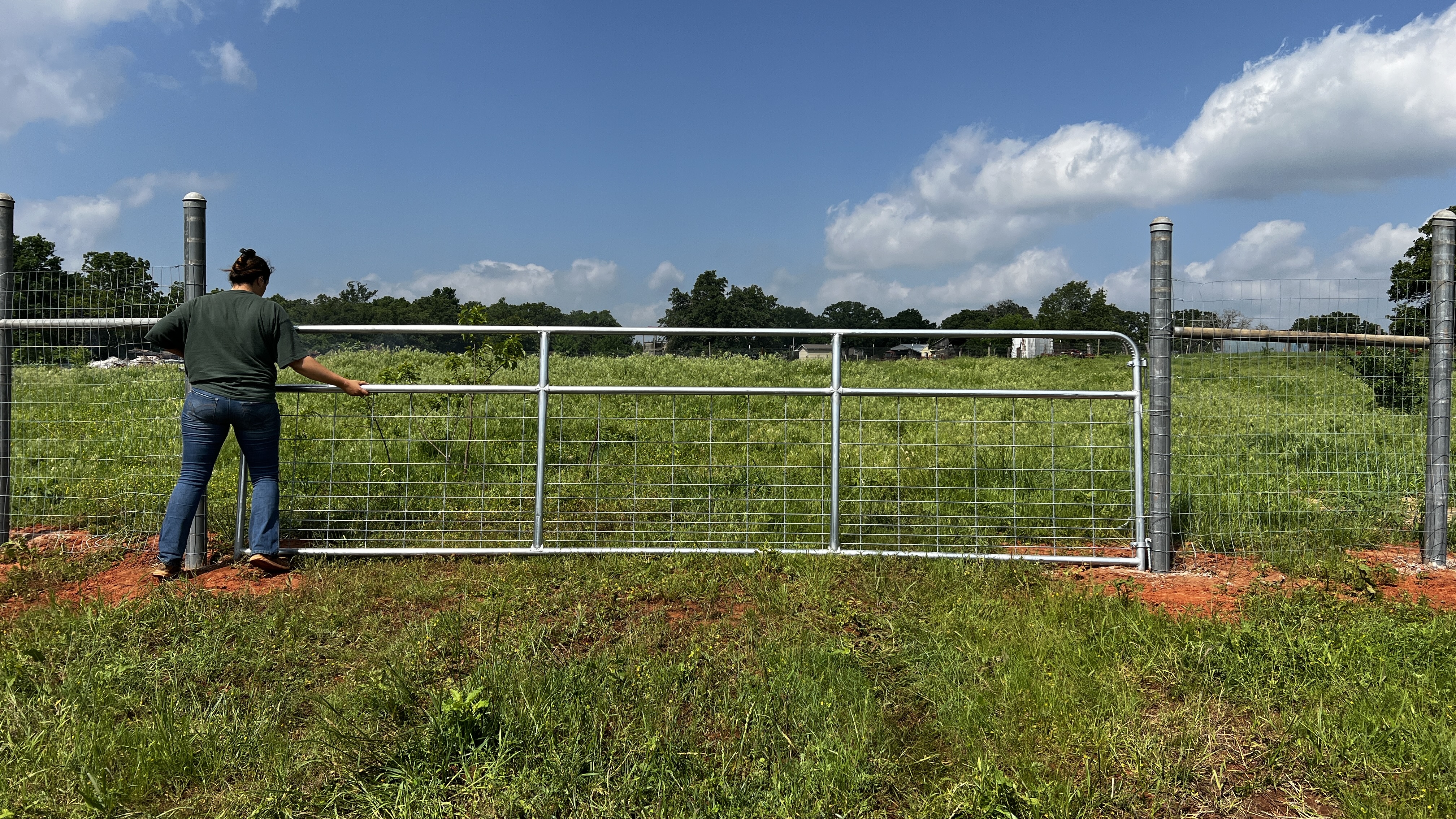 A woman installing a gate