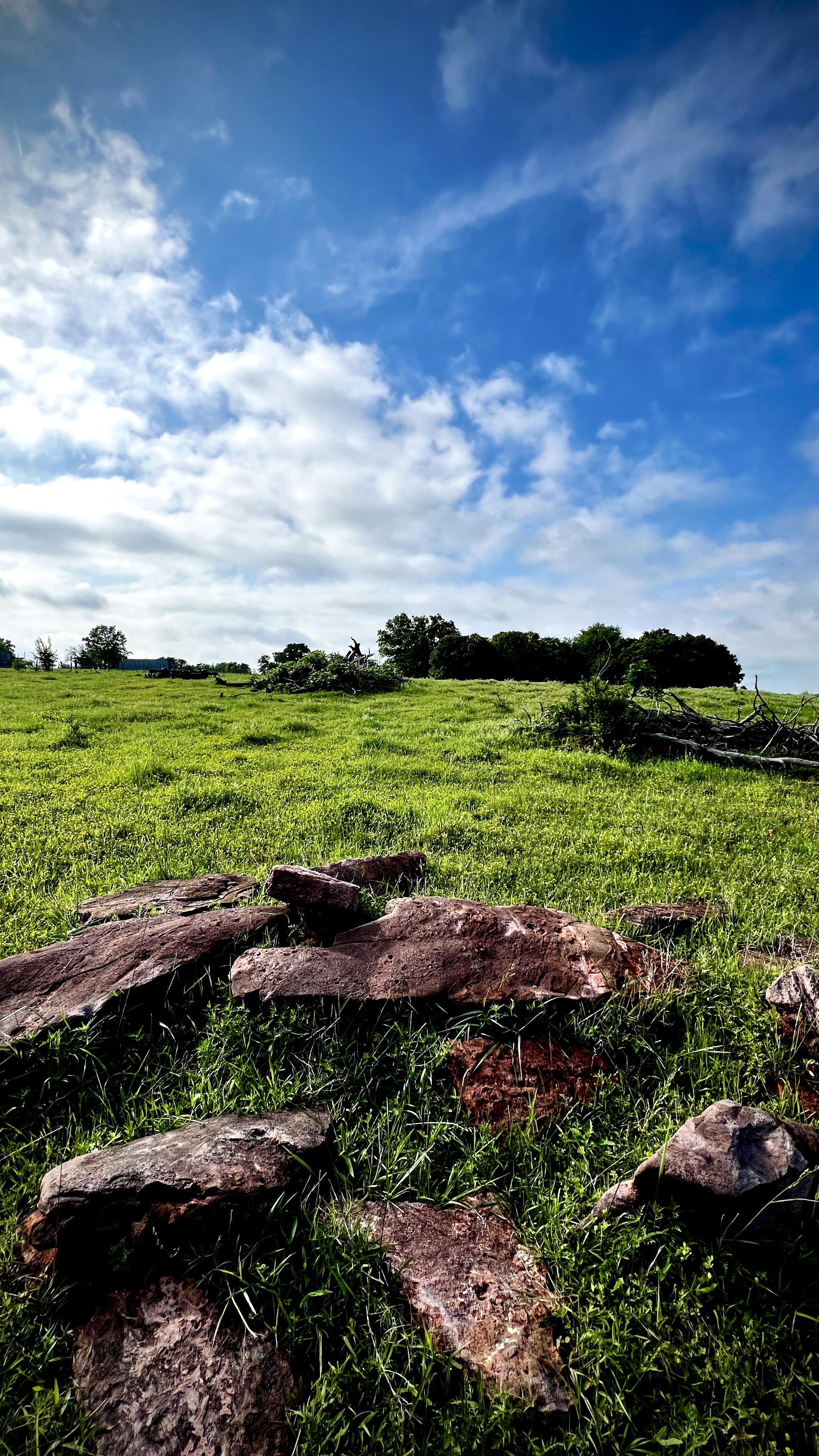 A pile of rocks in the foreground of a landscape photo