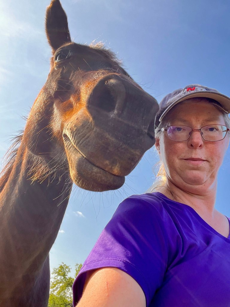 A horse and woman selfie.